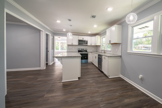 kitchen featuring a center island, white cabinetry, hanging light fixtures, and appliances with stainless steel finishes