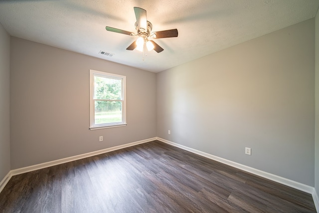 unfurnished room with a textured ceiling and dark wood-type flooring