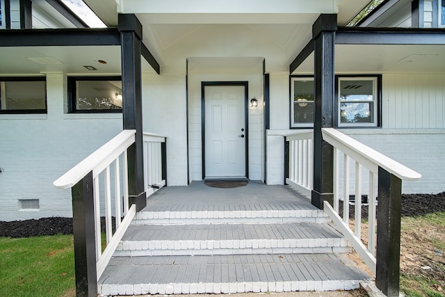 view of exterior entry featuring a porch