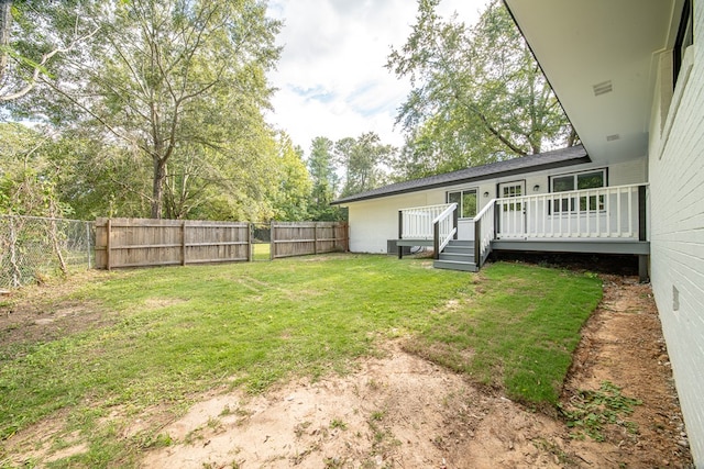 view of yard with a wooden deck