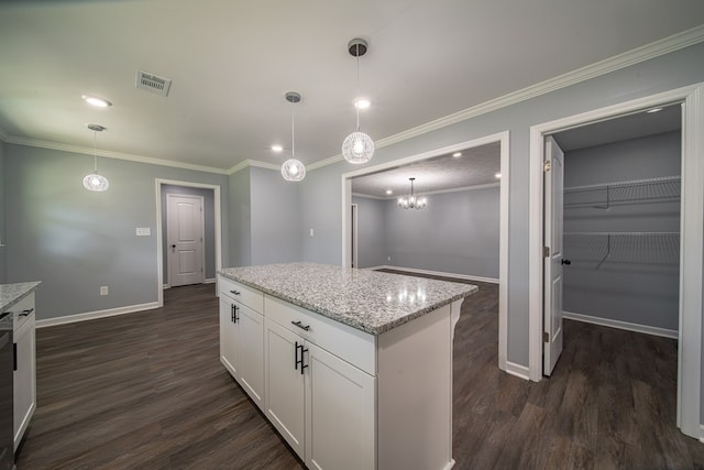 kitchen with pendant lighting, dark hardwood / wood-style floors, light stone counters, and white cabinetry