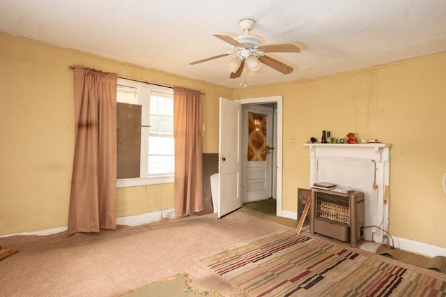 interior space featuring carpet flooring, ceiling fan, and baseboards
