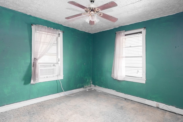 unfurnished room with baseboards, a textured ceiling, ceiling fan, and cooling unit