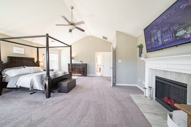 bedroom with vaulted ceiling, a fireplace with flush hearth, baseboards, carpet floors, and visible vents