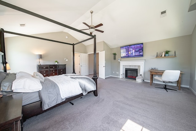 bedroom featuring lofted ceiling, carpet flooring, visible vents, and a tiled fireplace