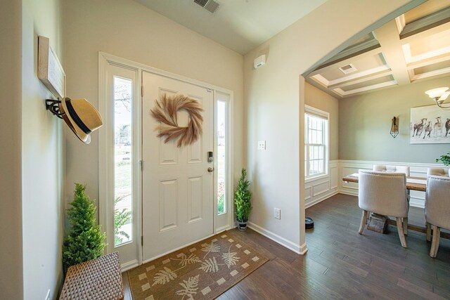 foyer entrance with coffered ceiling, visible vents, a notable chandelier, and dark wood-type flooring