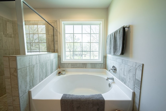 full bathroom with tiled shower and a garden tub
