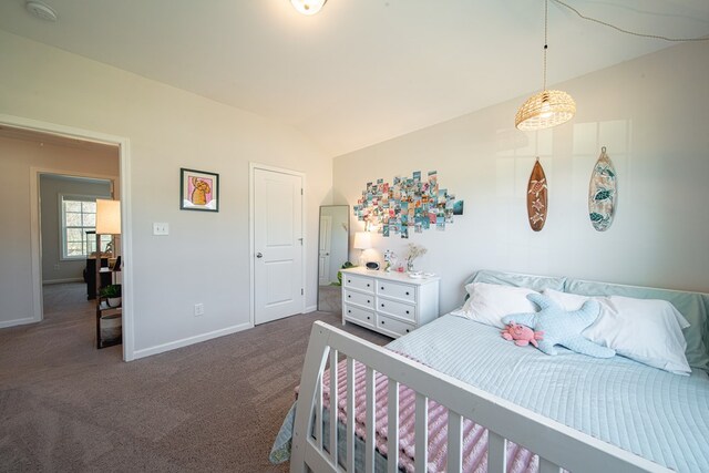 carpeted bedroom featuring baseboards and lofted ceiling