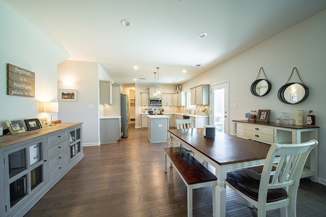 dining area with dark wood-style floors, baseboards, and recessed lighting