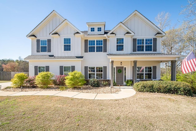 view of front of home featuring a front yard, fence, and board and batten siding