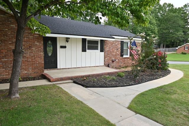 3919 Gray Fox Dr, Columbus, GA 31909 - ranch-style house featuring board and batten siding, a front lawn, roof with shingles, and brick siding