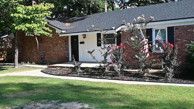 3919 Gray Fox Dr, Columbus, GA 31909 - view of front of home featuring a front yard, a shingled roof, and brick siding