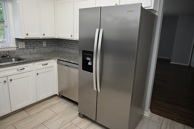 3919 Gray Fox Dr, Columbus, GA 31909 - kitchen featuring stainless steel appliances, white cabinetry, dark stone counters, light wood finished floors, and tasteful backsplash