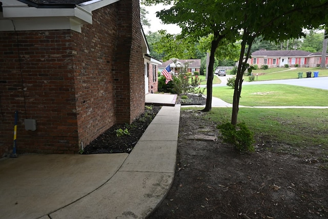 3919 Gray Fox Dr, Columbus, GA 31909 - view of side of property featuring brick siding, a lawn, and a residential view