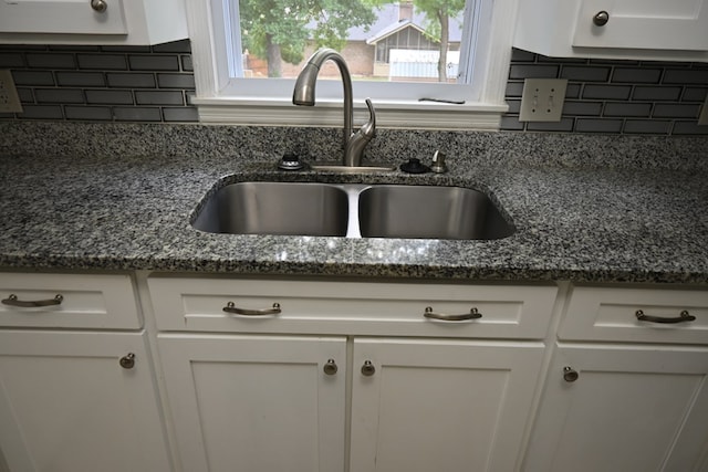 3919 Gray Fox Dr, Columbus, GA 31909 - kitchen view of tasteful backsplash, dark stone counters, and white cabinets