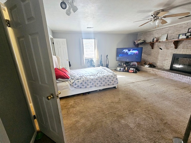 bedroom featuring carpet floors, a brick fireplace, brick wall, and visible vents