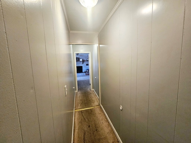 corridor featuring wood walls and ornamental molding