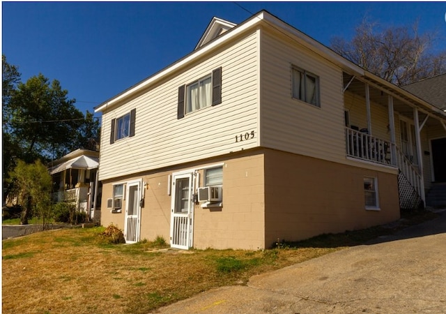 view of property exterior featuring cooling unit and a yard