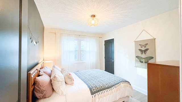 122 Malida Creek Ter, Pine Mountain, GA 31822 - bedroom featuring baseboards, a textured ceiling, and wood finished floors