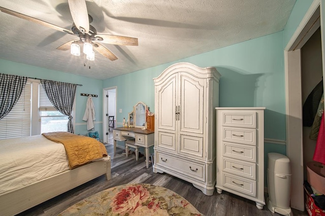 bedroom featuring a textured ceiling, ceiling fan, and dark wood-type flooring