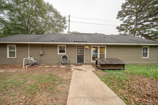 rear view of house with a lawn