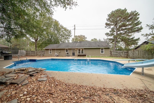 view of pool featuring a water slide and a trampoline