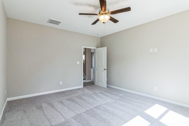 empty room with ceiling fan and light colored carpet