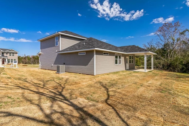 rear view of property with a patio, cooling unit, and a yard