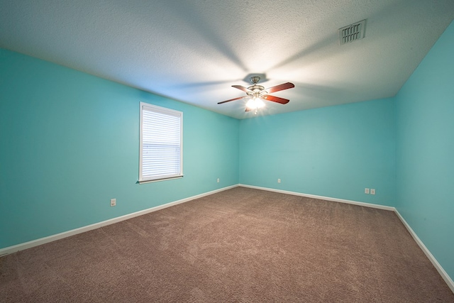 carpeted empty room featuring a textured ceiling, a ceiling fan, visible vents, and baseboards