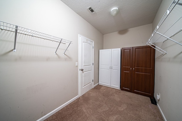 spacious closet with visible vents and carpet flooring