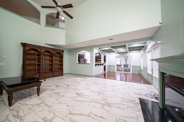 living room with marble finish floor, visible vents, a fireplace, and ceiling fan