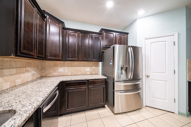 kitchen with dark brown cabinetry, dishwasher, light stone counters, stainless steel refrigerator with ice dispenser, and light tile patterned flooring