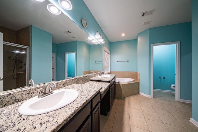 bathroom with visible vents, toilet, tile patterned floors, a garden tub, and a sink