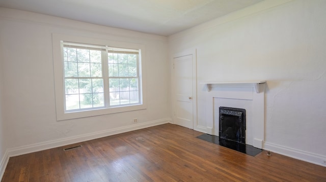 400 Lawrence St, Hogansville, GA 30230 - unfurnished living room featuring dark wood-style floors and a fireplace with flush hearth