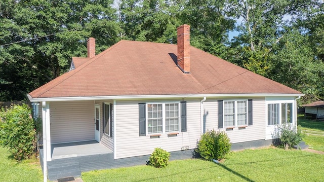400 Lawrence St, Hogansville, GA 30230 - view of front facade with a chimney, a front lawn, covered porch, and roof with shingles