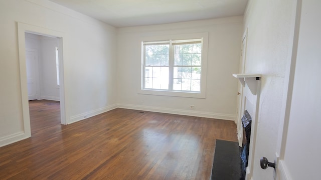 400 Lawrence St, Hogansville, GA 30230 - unfurnished living room with dark wood-style flooring and a fireplace with flush hearth