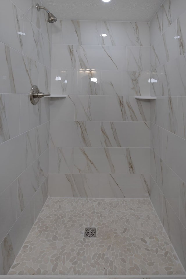 bathroom with tiled shower