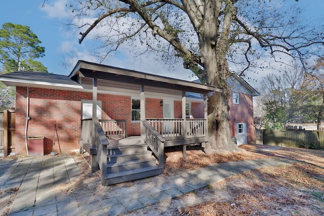 back of house with a wooden deck