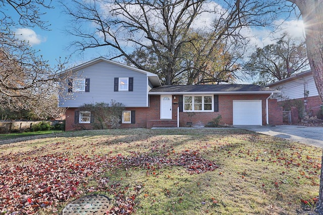 split level home featuring a garage and a front lawn