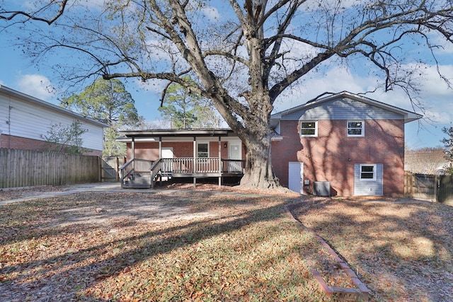 rear view of property with a yard and a deck