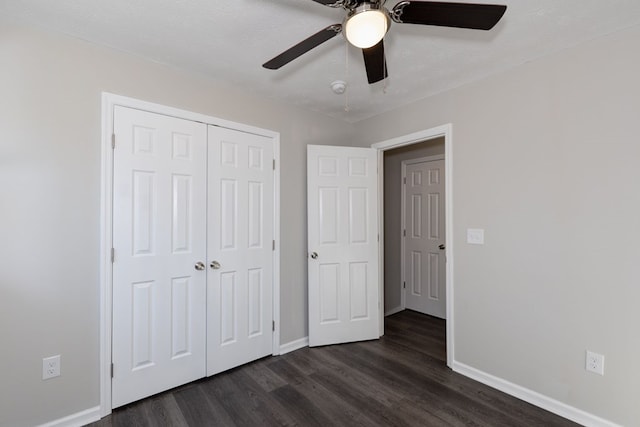 unfurnished bedroom with a textured ceiling, ceiling fan, a closet, and dark hardwood / wood-style floors