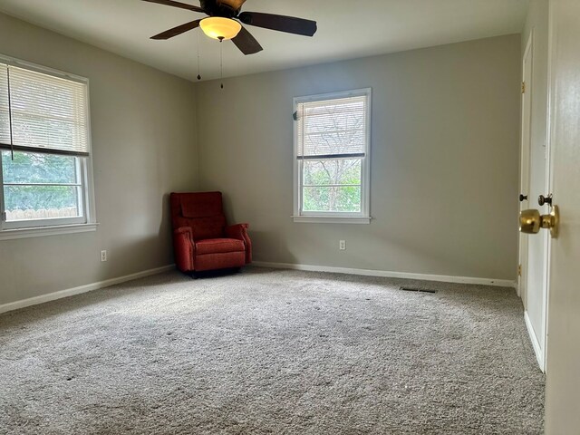 corridor featuring carpet floors, a sink, visible vents, and baseboards