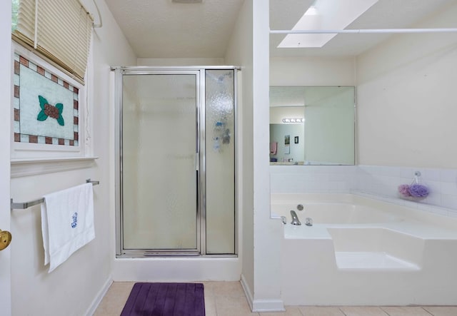 bathroom featuring tile patterned flooring, baseboards, a bath, and a shower stall