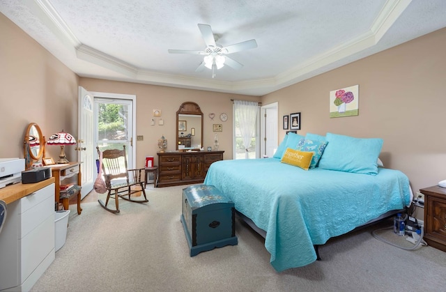 bedroom with crown molding, a tray ceiling, and light colored carpet