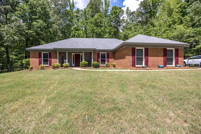 single story home featuring brick siding and a front yard
