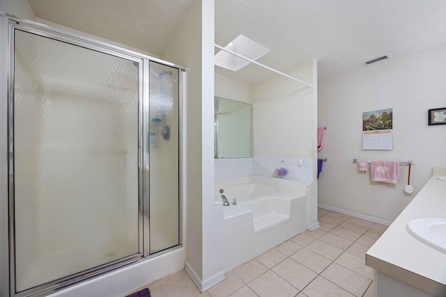 bathroom featuring a stall shower, visible vents, tile patterned flooring, and a garden tub