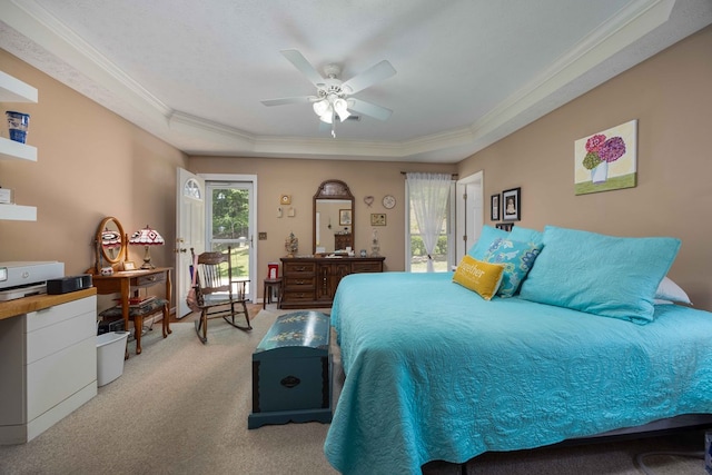 bedroom with a tray ceiling, ornamental molding, ceiling fan, and light carpet