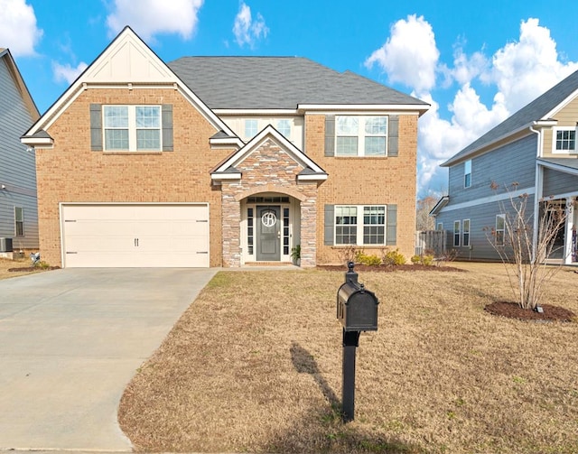 view of front of property with a garage, a front yard, and central AC unit