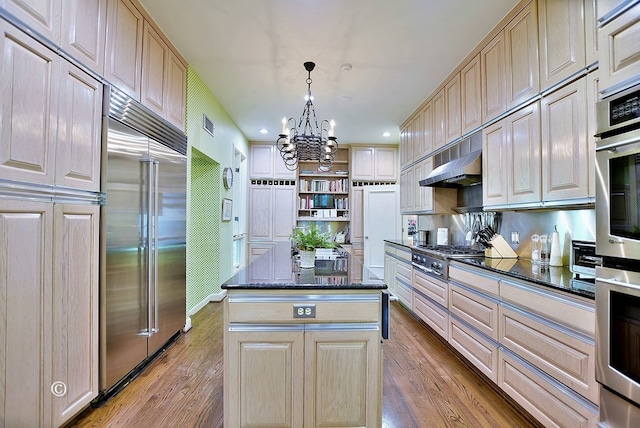 6528 Standing Boy Dr, Columbus, GA 31904 - kitchen featuring wood finished floors, a chandelier, open shelves, appliances with stainless steel finishes, and a center island