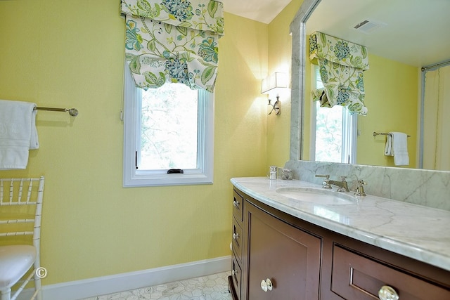 6528 Standing Boy Dr, Columbus, GA 31904 - bathroom featuring baseboards, visible vents, a wealth of natural light, and vanity